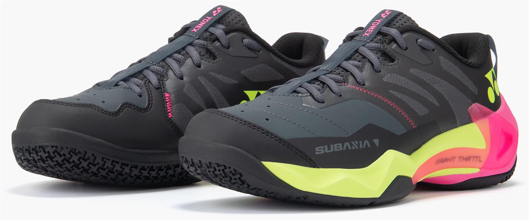 Yonex Subaxia GT Men's Badminton Shoes in dark grey feature neon yellow, pink, and green accents, GRPHT THRTTL technology, the "SUBAXIA" branding on the side, and a textured sole designed for top performance.