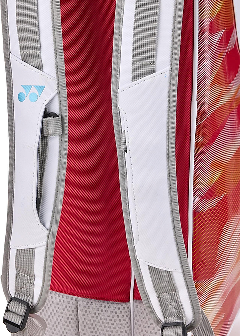 Close-up of Yonex 02626EX Expert 6 Racket Badminton Bag’s shoulder straps with white and gray padded mesh, blue logo, red back panel, vibrant red-orange sides, and Thermo Guard protection.