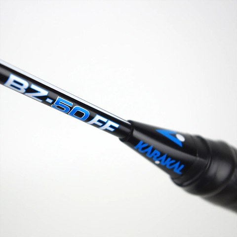 Close-up of a Karakal Black Zone BZ 50 badminton racket, black with blue and white text "BZ-50 FF" and "KARAKAL" near the tip against a plain background, made with innovative Fast Fibre Graphite for enhanced performance.