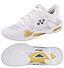 The Yonex Power Cushion Eclipsion Z3 Men's Badminton Shoes in white and gold feature a geometric upper design, textured grip sole with a central gold diamond for cushioning and repulsion, and the Yonex logo displayed on the tongue and side.