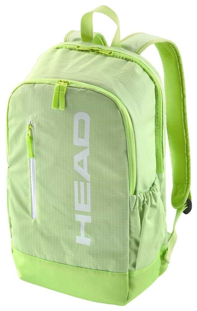 The HEAD BASE Badminton Backpack 17L - SG is lime green with "HEAD" printed vertically in white on the front pocket. It includes a zippered front pocket, racket compartment, side mesh pockets, padded shoulder straps, and features a top handle and zipper pulls.