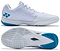 The Yonex Power Cushion Aerus Z2 Men's Badminton Shoes in White/Blue feature a mesh upper, cushioned Power Cushion sole, textured outsole, and Aerus Z2 branding on the heel, shown from the side and bottom.