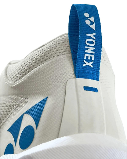 Close-up of the heel on Yonex Power Cushion GRPHT THRTTL Concept Men's Badminton Shoes, showing a blue pull tab with the Yonex logo and advanced Power Graphite technology for superior court stability.