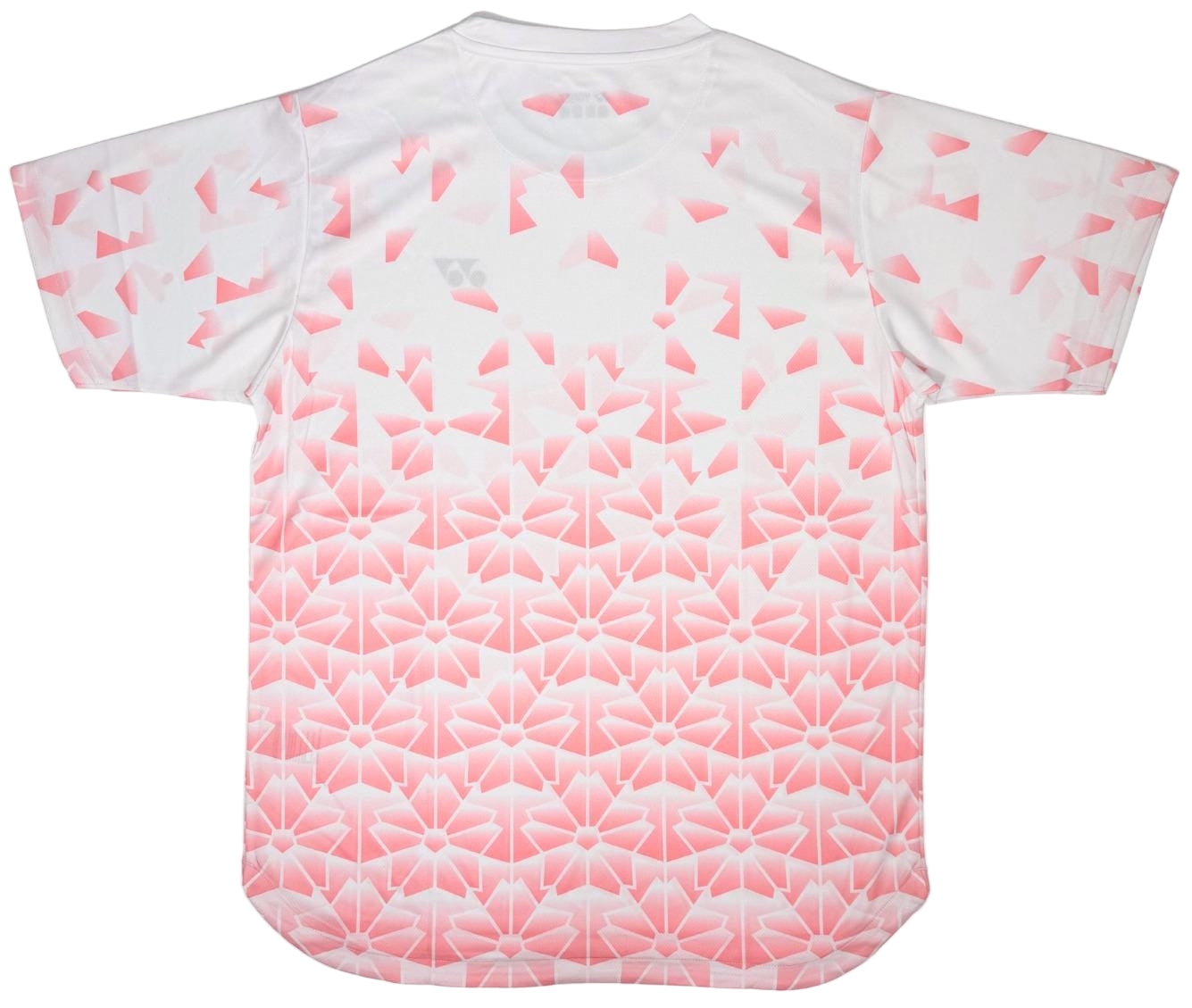 The Yonex YTM2025B Men’s Badminton T-Shirt in white features a pink geometric floral ombre pattern with interlocking shapes and triangles, offering a quick-dry, stylish look for active players.