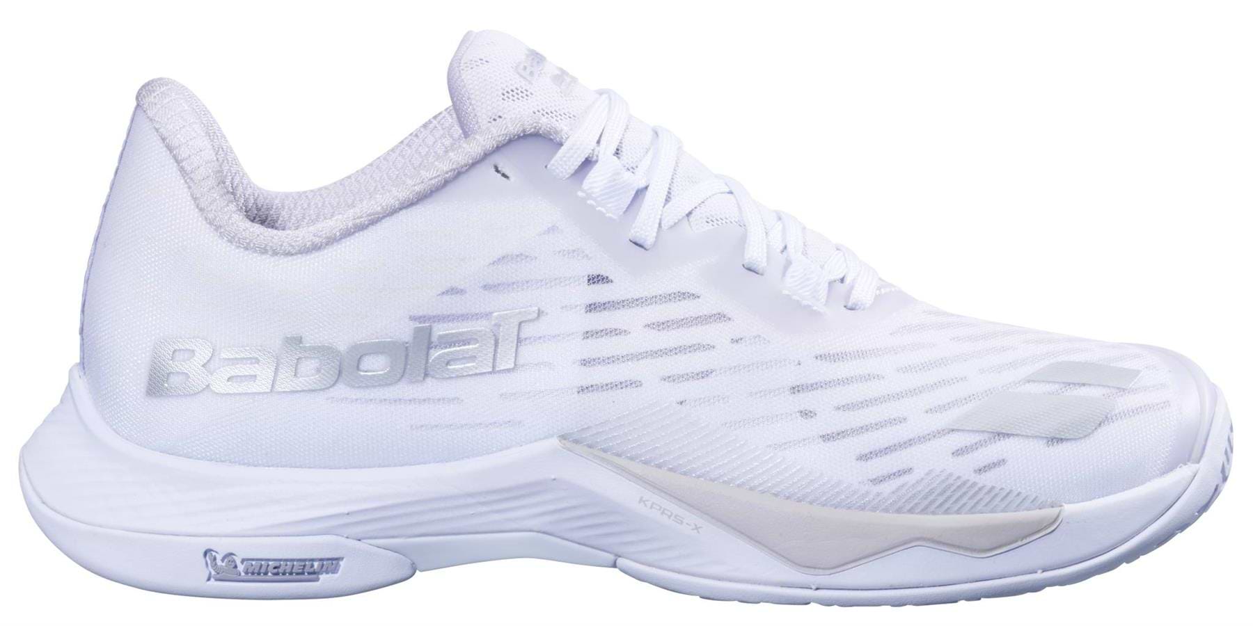 The Babolat Shadow Tour 5 Women's Badminton Shoe in white features gray accents, a mesh upper, and the Michelin logo on the sole, shown from a side view.