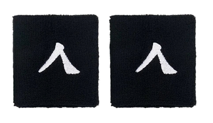 The Kanso 7cm Wristband - 2 Pack offers two black wristbands with a white abstract symbol resembling a stylized letter, crafted from absorbent fabric for maximum comfort, elegantly highlighted on a simple white backdrop.