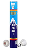 A blue cylindrical container from Snowpeak, featuring mountain designs and foreign text, contains BWF-approved Snowpeak C1101 Feather Shuttles in white. In front of the container, one shuttlecock stands upright while another lies on its side.