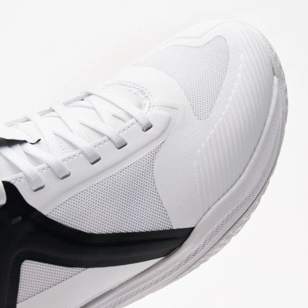 Close-up of Kanso's Equilibrium EQx3 Unisex Badminton Shoes in white/black; featuring Speedlight Foam for enhanced performance, a textured surface, white laces, and a detailed sole that highlights modern sportswear aesthetics and superior shock absorption.