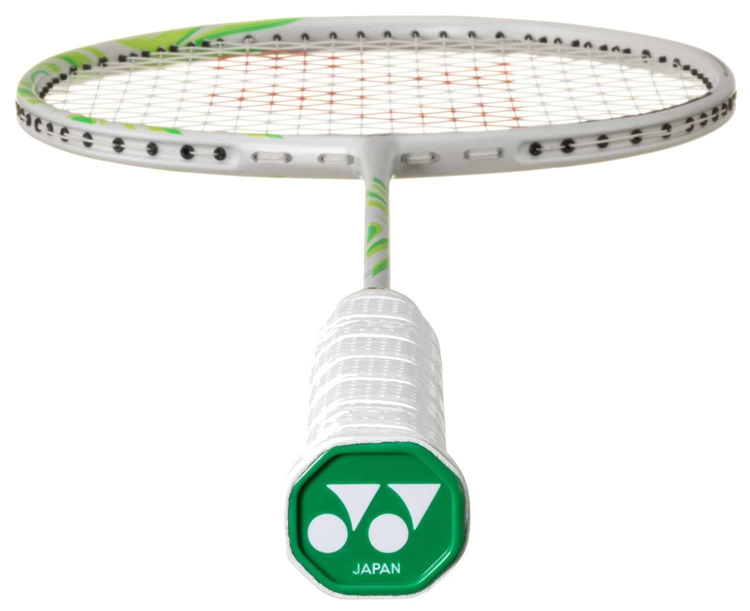 A close-up of the Yonex Astrox 100 ZZ VA Viktor Axelsen Badminton Racket in Greyish Beige, featuring a white handle with a green cap marked "JAPAN," the Yonex logo, and visible strings in the background.