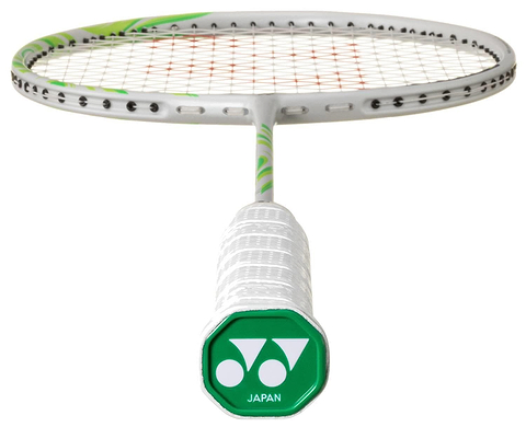 A close-up of the Yonex Astrox 100 ZZ VA Viktor Axelsen Badminton Racket in Greyish Beige, featuring a white handle with a green cap marked "JAPAN," the Yonex logo, and visible strings in the background.