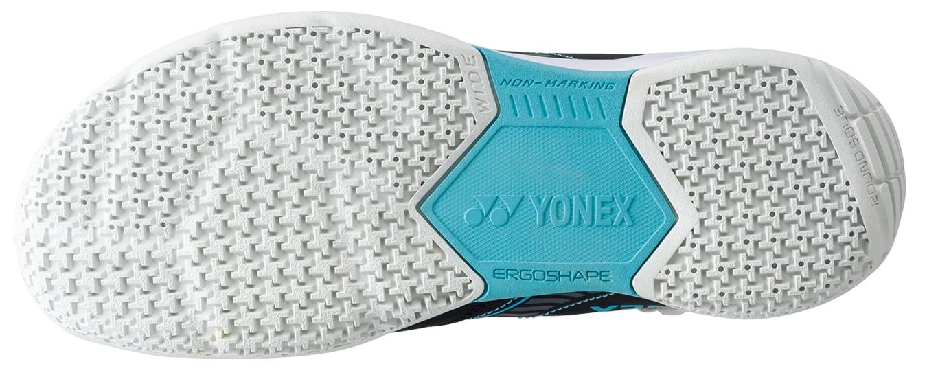 The Yonex Power Cushion Strider Flow sports shoe sole, ideal for badminton, features a white textured tread with a bright blue section marked "NON-MARKING," "YONEX POWER CUSHION," and "ERGOSHAPE.