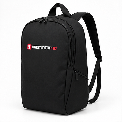 The BadmintonHQ Badminton Backpack - Black features a front zipper pocket, adjustable straps, "BADMINTON HQ" in white/red, and a small red logo—perfect for carrying your badminton kit.