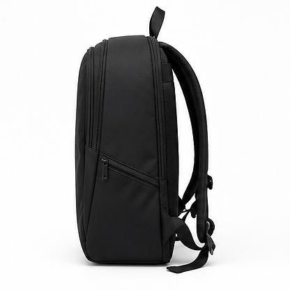 Side view of the BadmintonHQ Badminton Backpack - Black, featuring two zippered compartments, padded shoulder straps, and a top handle. This sleek, minimalist bag by BadmintonHQ is ideal for carrying your badminton kit for daily use or travel.