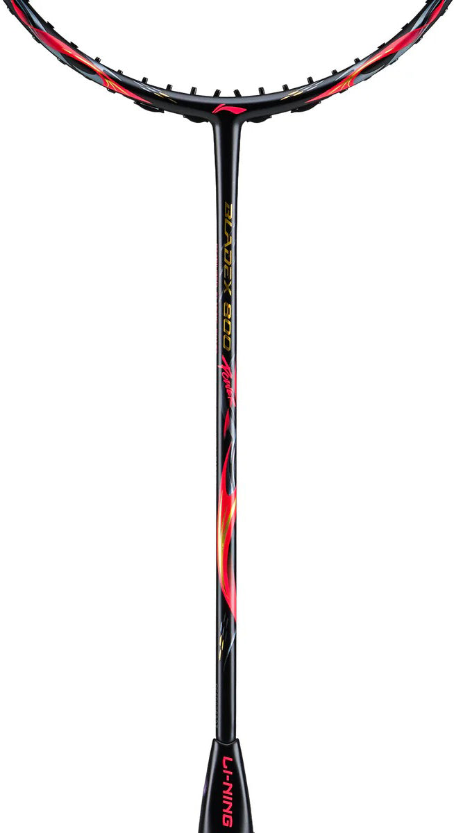 Close-up of the Li-Ning BladeX 800 Power Badminton Racket - Lava Red, showing its black and red design, M46X carbon shaft, yellow "3D CALIBAR 900" text with flame graphics, and prominent Li-Ning branding on the handle.