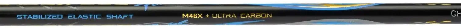 Close-up of the Li-Ning BladeX 800 Speed Badminton Racket - Storm Blue shaft, featuring blue, yellow, and gray accents. The text shows "STABILIZED ELASTIC SHAFT" in blue and "MAXI / ULTRA CARBON" in yellow on this head-light racket.