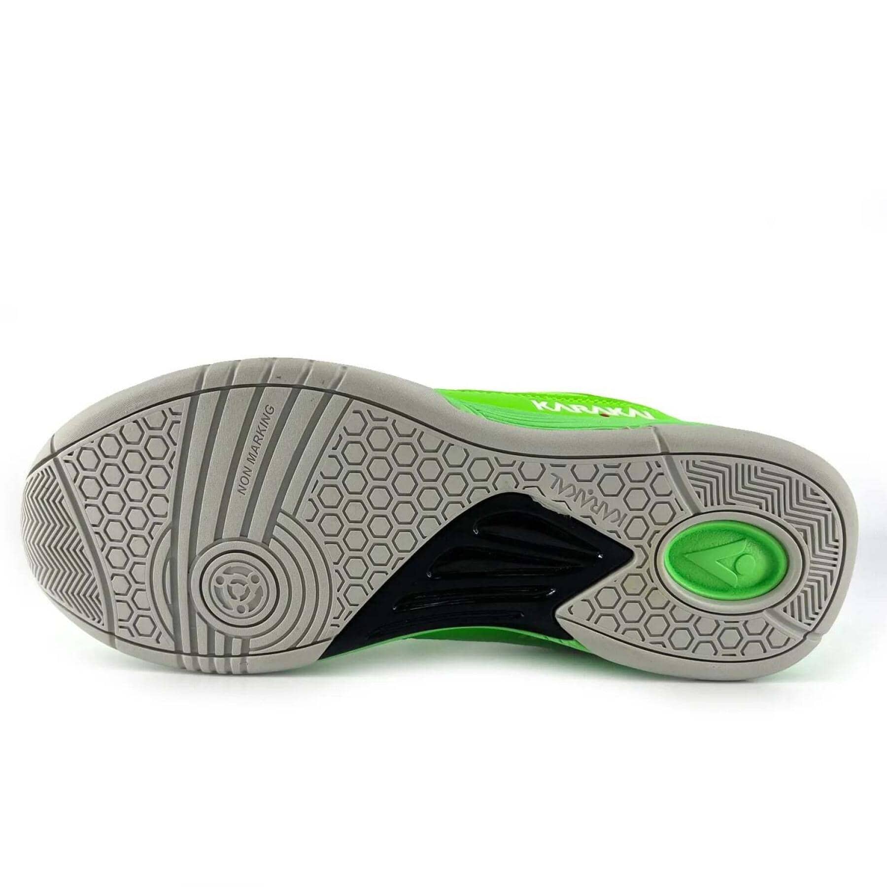 The image displays the sole of the Karakal KF Pro Lite Badminton Shoes in green, ideal for badminton enthusiasts. It features hexagonal and circular tread patterns for lateral stability, with text that reads "NON MARKING" and "KARAKAL KF ProLite." A small logo embellishes the heel area.