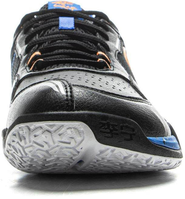 A close-up front view of the Li-Ning Saga III Lite Men's Badminton Shoes in black, featuring orange and blue accents, a white textured sole, Li-Ning Cloud cushioning, and embossed Chinese characters on the toe.