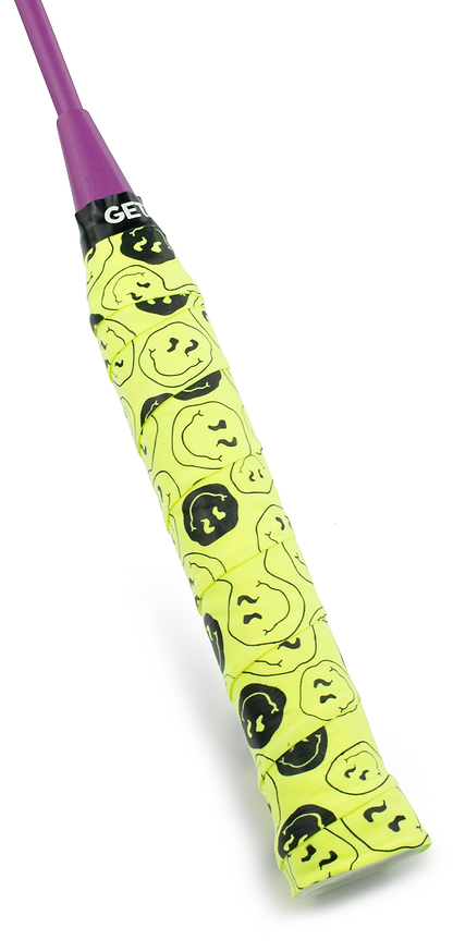 The Get A Grip Badminton Overgrip - Smiley by Get A Grip features a yellow grip with black smiley faces and a purple top section—perfect for anyone who loves unique sports gear or wants a fun badminton gift.