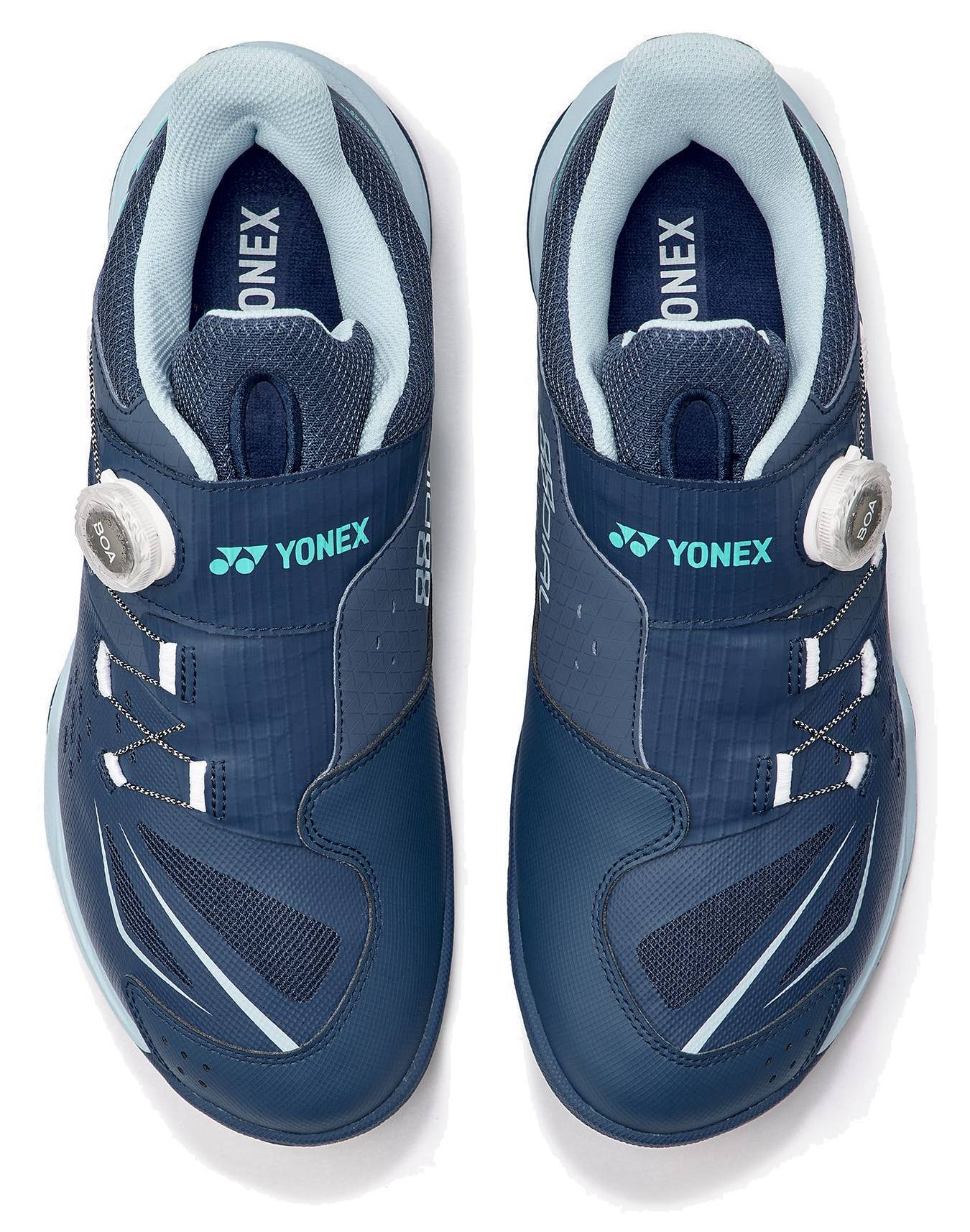 A pair of Yonex Power Cushion 88 Dial 3 Wide Unisex Badminton Shoes in navy and white, shown from above, featuring white BOA Fit System adjustment dials on the sides and “YONEX” branding on the tongues and straps. Designed for a wide fit, these shoes incorporate advanced Power Cushion 88 Dial technology for improved comfort and performance.