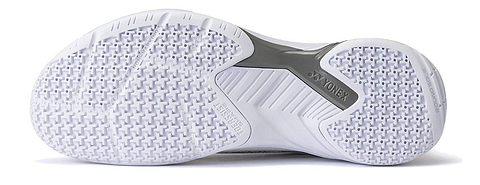 The image shows the white textured sole of the Yonex Power Cushion Cascade Accel Unisex Badminton Shoes in White / Orange, featuring intricate grip patterns and a gray support section in the middle—an excellent choice for players seeking an intermediate model with reliable Yonex Power Cushion technology.