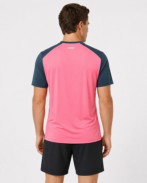 A man faces away from the camera, wearing a K-Swiss Hypercourt Mix Melange Men's Badminton T-Shirt in Stargazer/Pink and black shorts, against a plain white background.