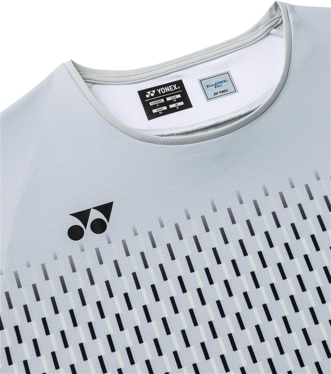 Close-up of the Yonex 10713EX Crew Neck Men's Badminton T-Shirt in silver grey, showing a black Yonex logo on the chest and a pattern of small black and white rectangles. Moisture-wicking tags are visible at the collar.