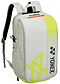 The Yonex 52512VA Viktor Axelsen Club Badminton Backpack in greyish beige features neon yellow accents, a black Yonex logo, diagonal front stripes, padded shoulder straps, and a top handle. Inspired by the Viktor Axelsen Signature line.