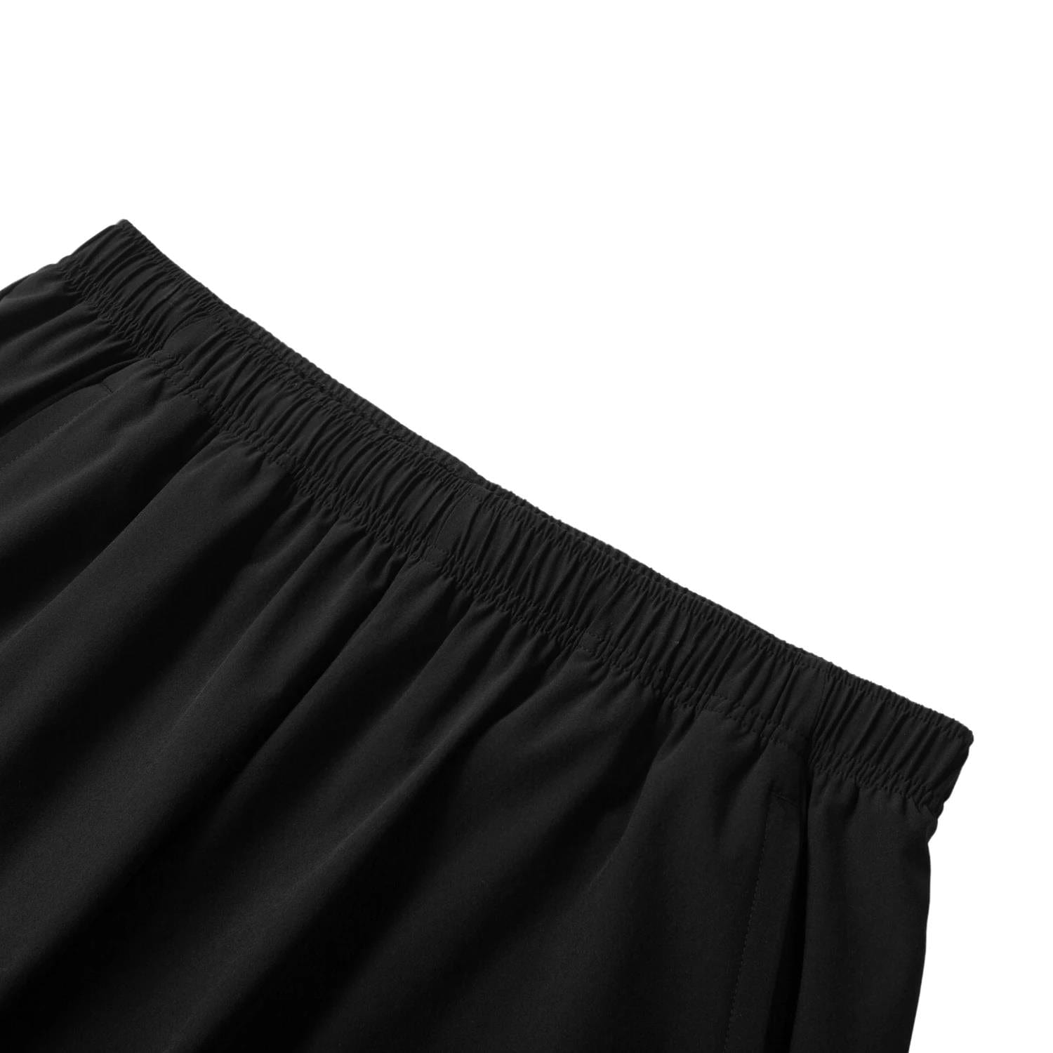 Close-up of Li-Ning Tournament Men's Badminton Shorts - Black, featuring an elastic waistband made with AT DRY technology for comfort and flexibility. The shorts, highlighted against a white background, epitomize high-performance badminton apparel from Li-Ning.