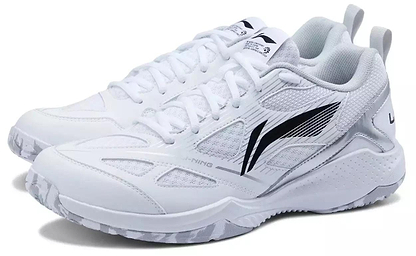 The Li-Ning Blast JF-01 Lite Unisex Badminton Shoes in white feature black and gray accents, mesh panels, textured soles, and heel pull tabs for a sporty look, offering a lightweight build and high-traction outsole.