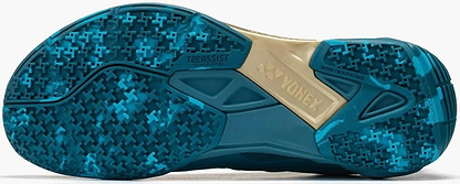Close-up of the Yonex Power Cushion Cascade Drive 3 Unisex Badminton Shoes - Peacock Blue sole, showing blue and teal grip patterns, "NON-MARKING," "TOE ASSIST SHAPE," a beige midfoot with the Yonex logo, and branded details.