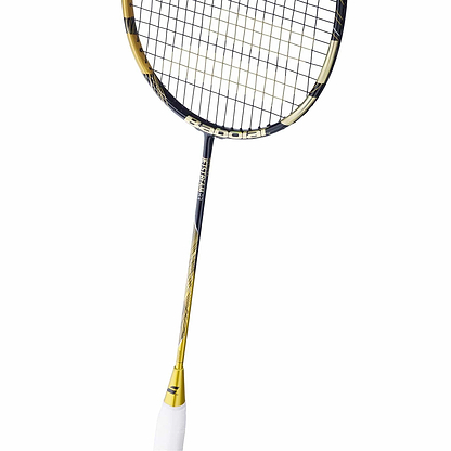 The Babolat Jetstream 83 4U Badminton Racket in gold and black offers excellent maneuverability. Its sleek design features a white grip handle, tightly woven strings, and prominently displays the Babolat brand name on the frame.