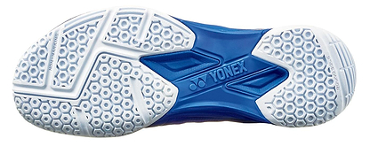 The image shows the sole of the Yonex Power Cushion Aerus X2 Unisex Badminton Shoe in navy blue, with a blue center bearing the Yonex logo, white hexagonal grooves for traction, and lightweight Power Cushion technology for comfort.