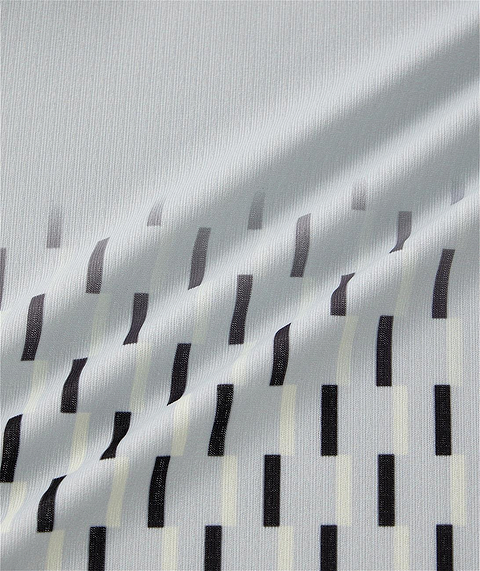 The Yonex 10713EX Crew Neck Men's Badminton T-Shirt in Silver Grey features light gray fabric with a subtle ribbed texture and staggered vertical black and off-white rectangular bars, offering stylish design and moisture-wicking comfort.