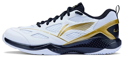 The Li-Ning Blast JF-01 Lite Unisex Badminton Shoes feature a white base with black and gold accents, black laces, a gold stripe, high-traction outsole, lightweight design, and the Li-Ning logo on the side.