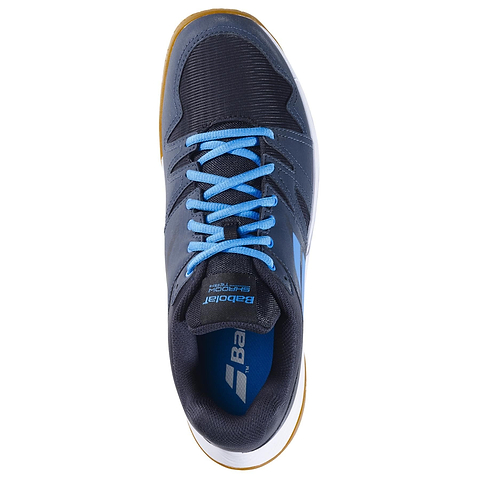 A single Babolat Shadow Team 2 Men's Badminton Shoe in black/grey with blue laces, a white and brown Michelin rubber sole, and "Babolat" branding on the tongue, shown top-down on a white background.