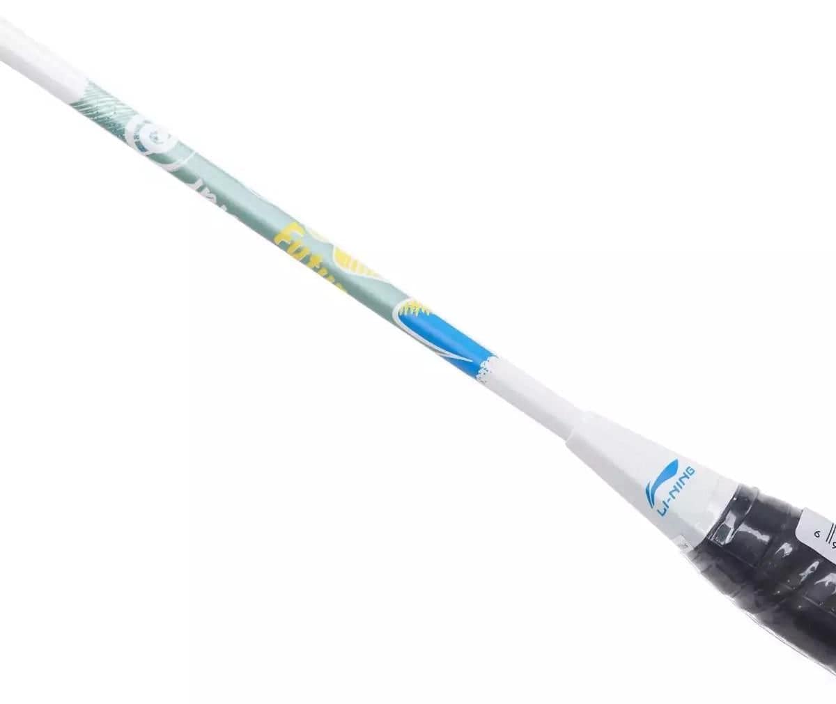 Close-up of a Li-Ning Axforce Kids Play Junior Badminton Racket - Pearl White. The shaft showcases a lightweight, colorful design in blue, green, and yellow. Its handle is wrapped in black grip tape with a white cover featuring the blue Li-Ning logo.