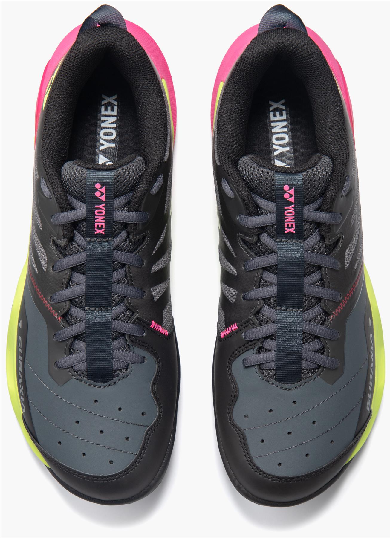 The Yonex Subaxia GT Mens Badminton Shoes in dark grey feature black soles, neon yellow sides, bright pink accents on the heels and tongue labels, and Power Cushion Rev technology for added comfort.