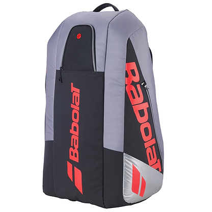 The Babolat RH9 Pure Strike 9 Racket Tennis Bag in Carbon Grey features water-repellent material, red branding, multiple compartments, and a top carry handle.