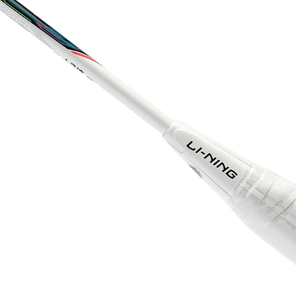 A close-up of a white badminton racket handle displays the brand name "Li-Ning" in black, emphasizing the lightweight and balanced design of the Li-Ning Halbertec Motor 5U Badminton Racket in Pink. The grip is enveloped in transparent plastic wrap, and the shaft is adorned with subtle colored accents.