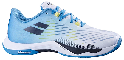 The Babolat Shadow Tour 5 Men's Badminton Shoes in Algier Blue feature light blue and white uppers, blue laces, black and yellow details, dynamic streaks, a Michelin sole logo—ideal for indoor court play.