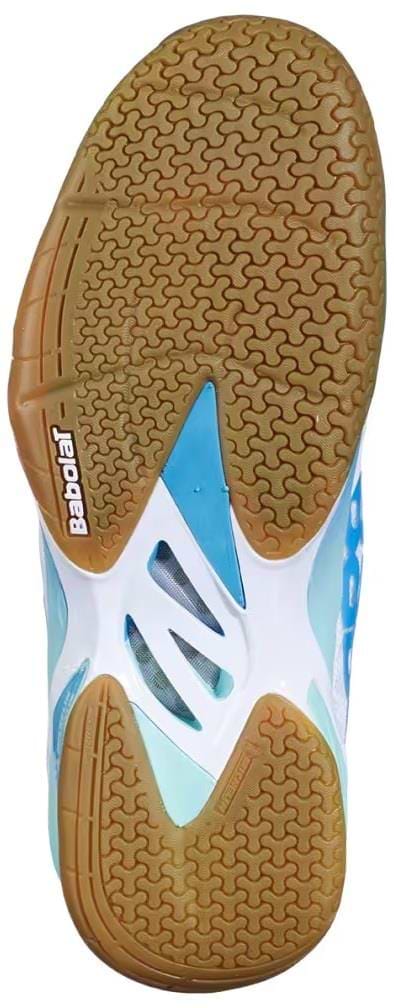Close-up of the sole of the Babolat Shadow 4 Womens Badminton Shoes - White Lagoon, showing brown textured rubber tread with white and blue accents and the Babolat logo by the heel.