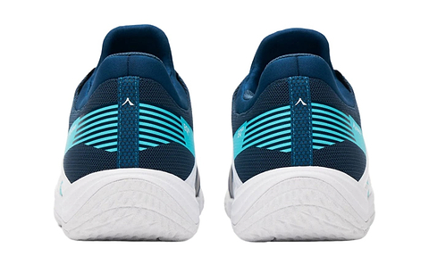A rear view of Kanso Equilibrium EQx3 badminton shoes in navy with teal and white accents. Their sleek design includes wave patterns and a thick white sole for better energy return, positioned side by side against a plain background.