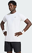 A man stands with hands on hips, wearing an adidas Climacool+ Freelift Pro Men’s Badminton T-Shirt in white—an advanced, quick-drying sports tee—paired with black shorts and white adidas wristbands, looking serious.