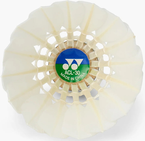 Close-up of a Yonex Aeroclear 30 Badminton Feather Shuttlecock, highlighting the white goose feathers and the base featuring a green and blue label with “ACL-30 Made in China” and the Yonex logo above, characteristic of shuttlecocks from this set of 12 by Yonex.