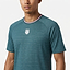 A man wears the K-Swiss Hypercourt Mens Melange 3 Badminton T-Shirt in Stargazer—a teal performance tee with a small white chest logo and a collar featuring red, white, and blue stripes—standing against a plain white background.