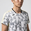 A man models the Yonex 10712YX Crew Neck Men's Badminton T-Shirt in Champagne, featuring a geometric gray-white design, small black chest logo, and quick-dry crew neck; shown from shoulders to mid-torso against a plain background.