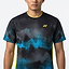 A man faces forward wearing the Yonex YTM2025A Men's Badminton T-Shirt in black, featuring an abstract black and blue design, yellow Yonex logo, quick-dry technology, and yellow trim on the collar and sides. Only his upper body is visible.