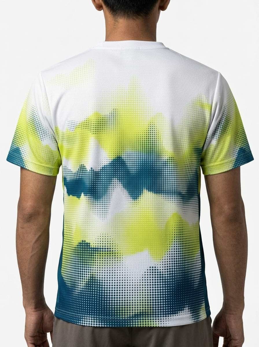 A person with short dark hair is seen from behind wearing a Yonex YTM2025A Mens Badminton T-Shirt - White by Yonex, showcasing a digital pixelated gradient design in yellow, green, blue, and white on performance fabric.