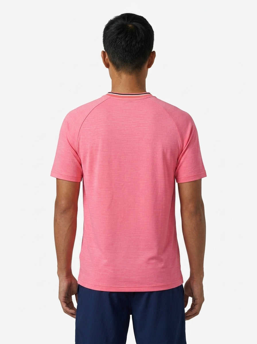 A man with short black hair faces away from the camera, wearing the K-Swiss Hypercourt Mens Melange 3 Badminton T-Shirt in pink and dark blue shorts, set against a plain white background.