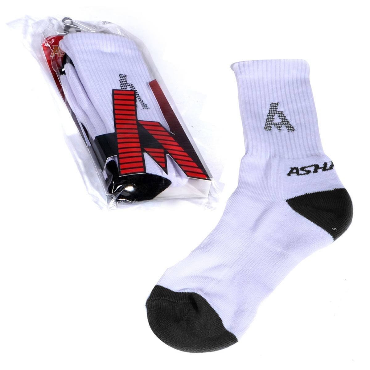 Displayed are the Ashaway Badminton Socks in a white and black color scheme, ideal for racket sports. One sock is shown lying flat on a white surface, while the other remains packaged with "ASTAR" visible. Designed by the brand Ashaway to reduce blistering, these socks feature their logo along with black heels and toes.
